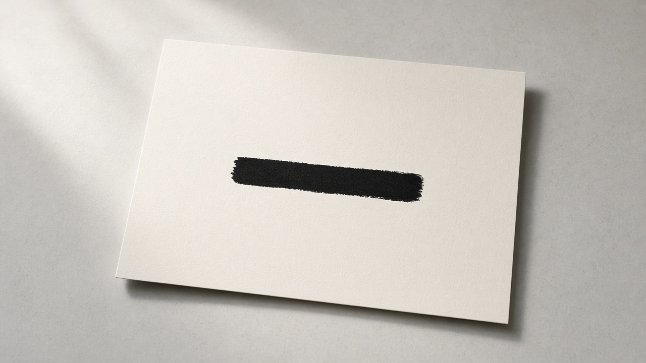 A cream sheet of paper with one black mark in the middle.